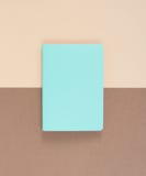 Turquoise notepad on brown background. Working place. Space for notes. Top view. Royalty Free Stock Image Turquoise notepad on brown background. Working place. Space for notes. Top view. Royalty Free Stock Image