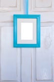 Turquoise Picture Frame Hanging on Distressed White Door Royalty Free Stock Photos Turquoise Picture Frame Hanging on Distressed White Door Royalty Free Stock Photos