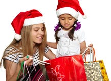 Två små flickor i päls-lock med shoppingpåsar Jul royaltyfri fotografi Två små flickor i päls-lock med shoppingpåsar Jul royaltyfri fotografi