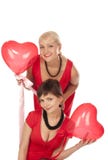 Twee mooie meisjes met rode hartballon stock foto Twee mooie meisjes met rode hartballon stock foto