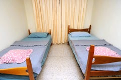 Twin Beds In Simple Motel Room Royalty Free Stock Photos