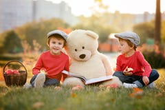 Two adorable little boys with his teddy bear friend in the park Royalty Free Stock Photos Two adorable little boys with his teddy bear friend in the park Royalty Free Stock Photos