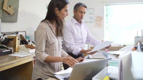 Two Architects Working With Plans In Office Together stock video footage Two Architects Working With Plans In Office Together stock video footage