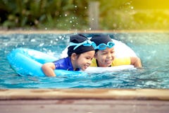 Two asian little girls having fun to swim in swimming pool stock photos Two asian little girls having fun to swim in swimming pool stock photos