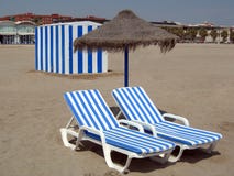 Two Beach Chairs Under Umbrella And A Cabin Royalty Free Stock Photography