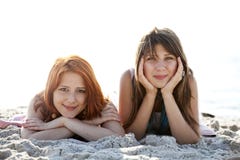 Two Beautiful Girls Lie On The Beach. Royalty Free Stock Photography Two Beautiful Girls Lie On The Beach. Royalty Free Stock Photography
