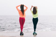 Two beautiful slender young girls are engaged in gymnastics on t stock photo Two beautiful slender young girls are engaged in gymnastics on t stock photo