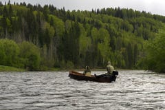 Two in a boat sailing along the river royalty free stock photo Two in a boat sailing along the river royalty free stock photo