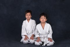 Two boys of the karate in a white kimono stock photos Two boys of the karate in a white kimono stock photos