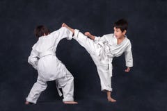 Two boys of the karateka in a white kimono battle stock photo Two boys of the karateka in a white kimono battle stock photo