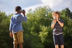 two-boys-play-tin-can-telephone-summer-80635016.jpg