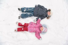 Two Children Lie On Snow Royalty Free Stock Images Two Children Lie On Snow Royalty Free Stock Images