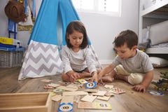 Two Children Playing Number Puzzle Game Together In Playroom royalty free stock images Two Children Playing Number Puzzle Game Together In Playroom royalty free stock images