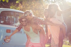 Two couples having piggy ride in park Stock Photography Two couples having piggy ride in park Stock Photography