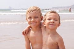 Two Cute Adorable Little Brothers Boys Sitting On The Beach Ocean Sea Stock Photography