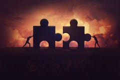 Two determined businessman pushing big jigsaw puzzle pieces to unite and complete the purpose. Business teamwork concept,