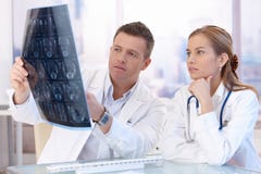 Two doctors studying x-ray image consulting royalty free stock photography Two doctors studying x-ray image consulting royalty free stock photography