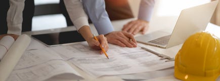 Two Engineers Working Together With Blueprint, Laptop And Tablet Stock Photos Two Engineers Working Together With Blueprint, Laptop And Tablet Stock Photos