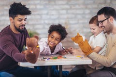 Two fathers play educational games with their children stock photography Two fathers play educational games with their children stock photography
