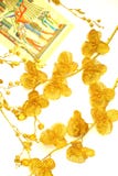 Two flowers of gold color, scattered, pattern on papyrus royalty free stock images Two flowers of gold color, scattered, pattern on papyrus royalty free stock images