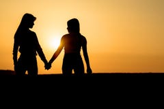 Two girls holding each other hands. Ladies couple on the beach. royalty free stock images Two girls holding each other hands. Ladies couple on the beach. royalty free stock images