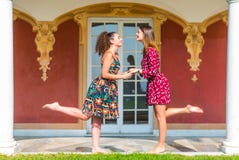 Two girls holding hands and having fun stock photography Two girls holding hands and having fun stock photography