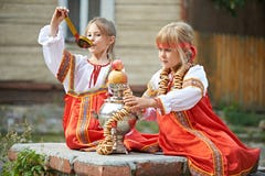 Two Girls In Russian National Costumes With Samovar Stock Photos Two Girls In Russian National Costumes With Samovar Stock Photos