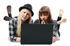 Two Girls Lies With Computer Stock Photo
