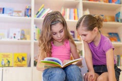 Two girls are reading an interesting book Stock Images Two girls are reading an interesting book Stock Images