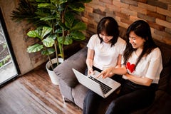 Two girls using laptop with a lot of un royalty free stock photo Two girls using laptop with a lot of un royalty free stock photo