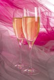Two Glasses of Champagne with Backlit Tulle Background #1 royalty free stock photo Two Glasses of Champagne with Backlit Tulle Background #1 royalty free stock photo