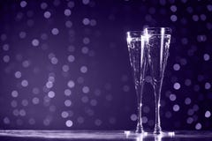 Two glasses of champagne on dark bokeh background. Ultra violet royalty free stock photos Two glasses of champagne on dark bokeh background. Ultra violet royalty free stock photos