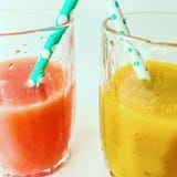 Two glasses of fresh juice with tubes. Two colorful fruit shakes. Summer and tropical smoothies. Cold blended drinks royalty free stock photography Two glasses of fresh juice with tubes. Two colorful fruit shakes. Summer and tropical smoothies. Cold blended drinks royalty free stock photography