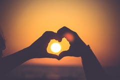 Two Hands Making a Heart with Sunset in Background Stock Photography Two Hands Making a Heart with Sunset in Background Stock Photography