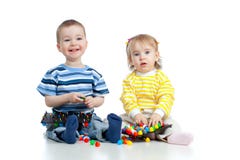 Two happy children play together with mosaic toy stock images Two happy children play together with mosaic toy stock images