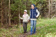 Two happy kids walking along forest path royalty free stock photo Two happy kids walking along forest path royalty free stock photo