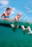 Two happy smiling childs sit on inflatable raft stock image Two happy smiling childs sit on inflatable raft stock image
