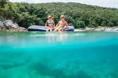 Two happy smiling childs sit on inflatable raft stock photo Two happy smiling childs sit on inflatable raft stock photo