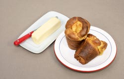 Two Home Baked Popovers And A Stick Of Butter Stock Photo Two Home Baked Popovers And A Stick Of Butter Stock Photo