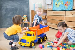 Two Kids Conflict Or Struggling For Toy Truck In Kindergarten Stock Photos