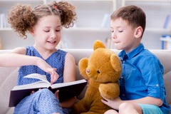 The two kids reading books at home royalty free stock photography The two kids reading books at home royalty free stock photography