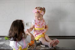 Two Little girl preparing cookies in kitchen at home royalty free stock photos Two Little girl preparing cookies in kitchen at home royalty free stock photos