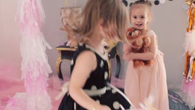 Two little girls with balloons on holiday stock video Two little girls with balloons on holiday stock video