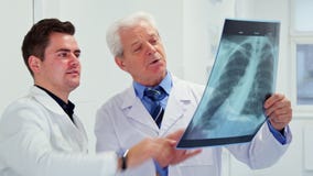 Two male doctors look at x-ray royalty free stock images Two male doctors look at x-ray royalty free stock images