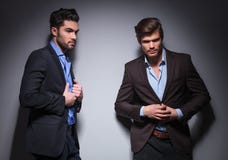 Two male fashion models posing in studio stock photo Two male fashion models posing in studio stock photo