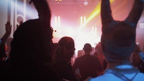 Two man with horns have drinks and talking at night club halloween party. Flashing colorful light stock video Two man with horns have drinks and talking at night club halloween party. Flashing colorful light stock video