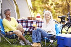 Two Mature Women Relaxing On Camping Holiday royalty free stock photo Two Mature Women Relaxing On Camping Holiday royalty free stock photo