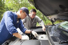 Two Mechanics fixing the car Stock Images Two Mechanics fixing the car Stock Images