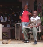 Two Men At Entrance To Small Shop In Cuba
