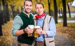 Men in bayrischer Tracht clinking glasses with beer stock photos Men in bayrischer Tracht clinking glasses with beer stock photos